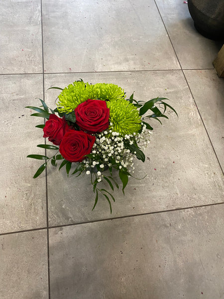 Shamrock and roses arrangement in a vase