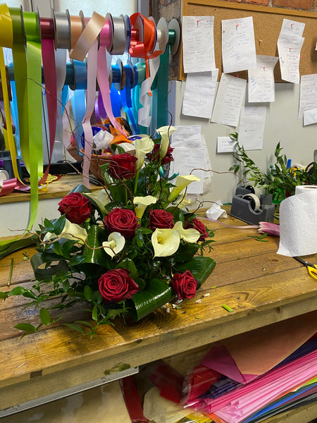 Calla lilies and roses arrangement